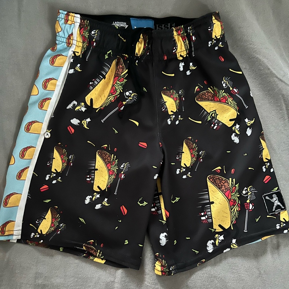 Kids lacrosse shorts- taco printed with lax sticks. Size YXS